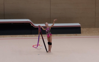 Olympic champion Alina Kabaeva helps Eva Kononova correct a mistake in a ribbon exercise