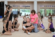 A gymnast with a coach during the training session