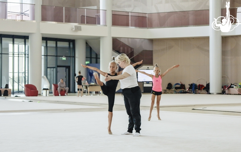 Russia’s Honored Coach Natalya Ovsyannikova works with a young gymnast