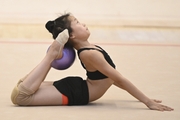 A young gymnast from China during the ball exercise