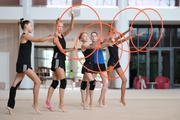 Gymnasts performing an exercise with hoops