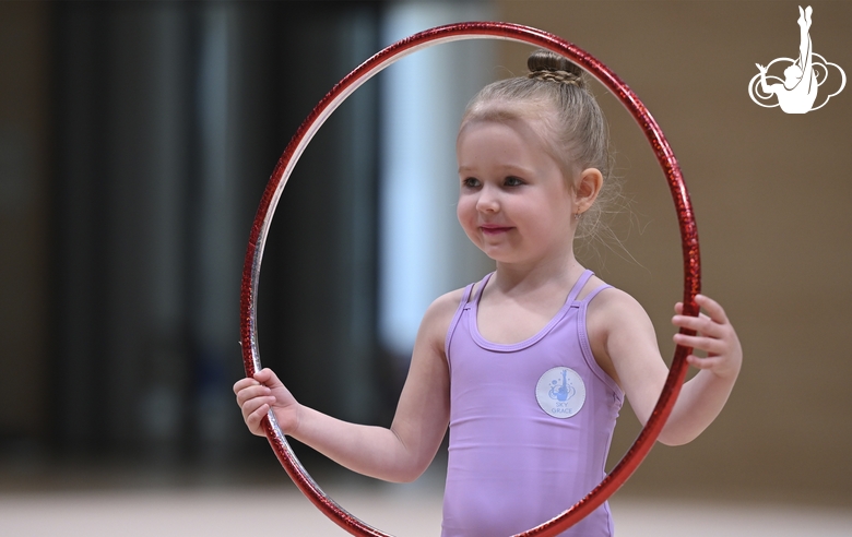 Young gymnast during an exercise with a hoop at the mAlinka tournament