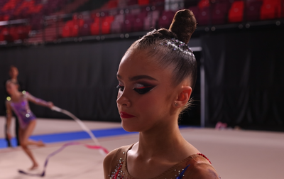 Alina Kabaeva encourages on Karolina Pakhtusova and Ksenia Savinova before their performances during the final of the Cup of the Strongest