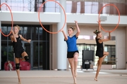 Gymnasts performing an exercise with hoops