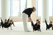 Academy Coach Anna Ustsova with young gymnasts during the exercise