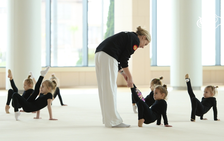 Academy Coach Anna Ustsova with young gymnasts during the exercise