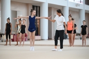 Coach Elizaveta Chernova with gymnasts during practice at the training camp in the Academy