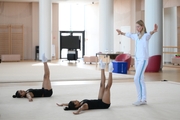 Gymnasts Kimaya Karle, Aryaa Nitesh Kadam and Academy coach Alina Protasova during training