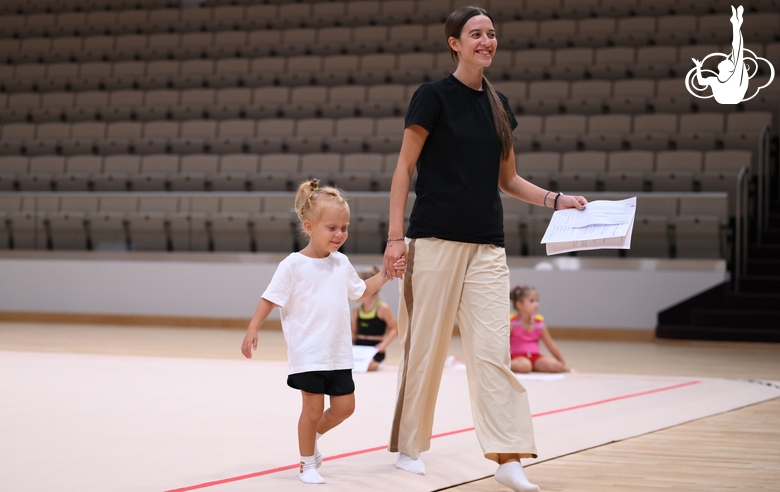 Academy coach Elizaveta Chernova with a young gymnast during the selection