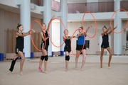 Gymnasts performing an exercise with hoops