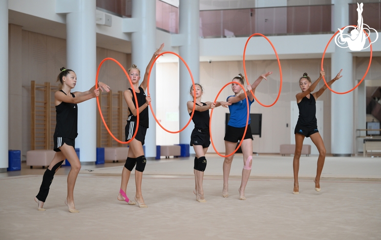 Gymnasts performing an exercise with hoops