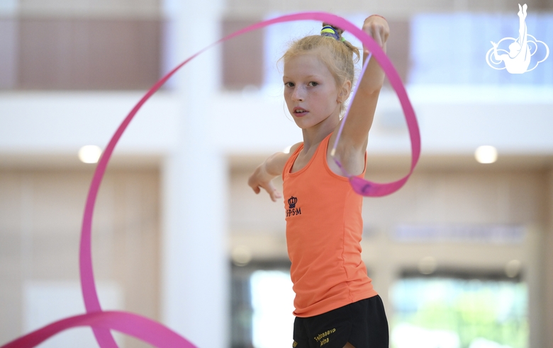 Gymnast performs an exercise with a ribbon