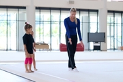 Coach Elizaveta Zorkina and young gymnasts during training