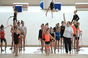 Gymnasts with a coach during class