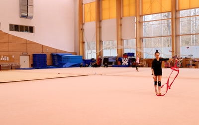 Olympic champion Alina Kabaeva shows Mariia Borisova how to add artistic details to her ribbon routine
