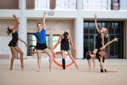 Gymnasts performing an exercise with hoops