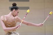 Gymnast during an exercise with clubs