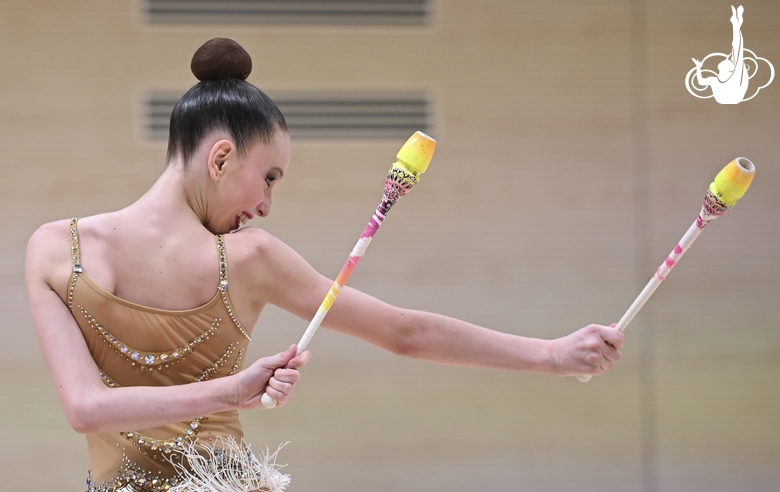 Gymnast during an exercise with clubs