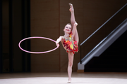 Young gymnast shows a hoop routine at the assessment training session