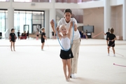 Coach Elizaveta Chernova and a young gymnast during training