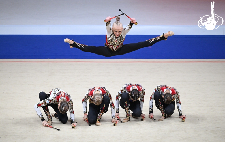 Academy group exercise gymnasts during the exercise with clubs