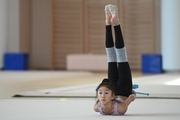 A gymnast from China during the exercise with clubs when training