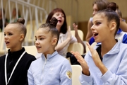 Kristina Voitenko, Ksenia Savinova and  Karolina Tarasova watch performance of gymnasts