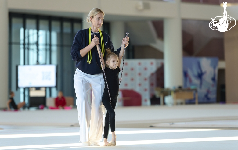 Academy Coach Anna Ustsova with a young gymnast during the exercise