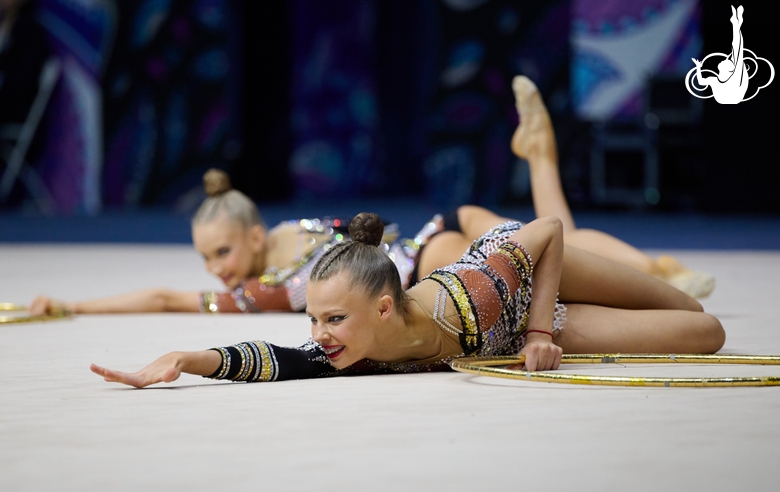 Group gymnasts during an exercise with hoops and clubs