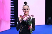 Mariia Borisova with her gold medal in the all-around after the awards ceremony
