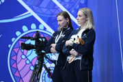 Choreographer Elena Egorova and coach Anna Ustsova during a group gymnasts' performance