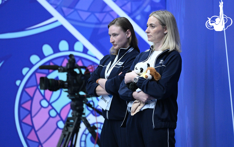 Choreographer Elena Egorova and coach Anna Ustsova during a group gymnasts' performance