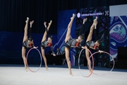 Group gymnasts during exercise with hoops and clubs
