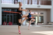 Gymnasts performing an exercise with hoops