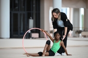 Academy coach Olesya Kovaleva with gymnast Nkenko Sita Davina Chanselvi during the hoop exercise