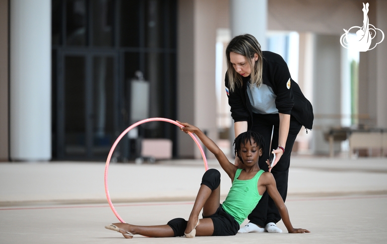 Academy coach Olesya Kovaleva with gymnast Nkenko Sita Davina Chanselvi during the hoop exercise